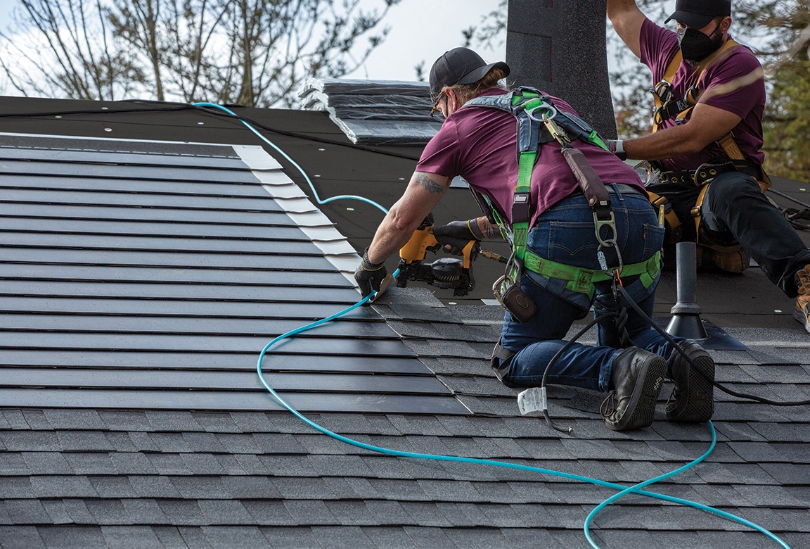 Traditional shingles are integrated into the solar installation to prevent leaks